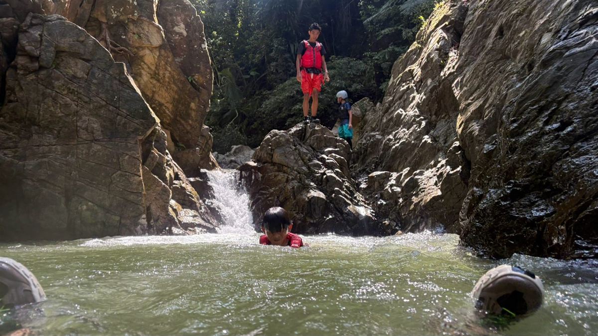 Swimming in a waterfall pool